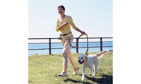 Woman running with a dog using a orangehands free running retractable dog leash, adjustable belt, padded handles.